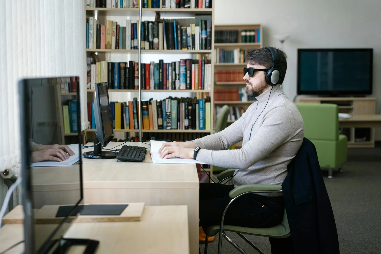 Vision-impaired man using assistive technology