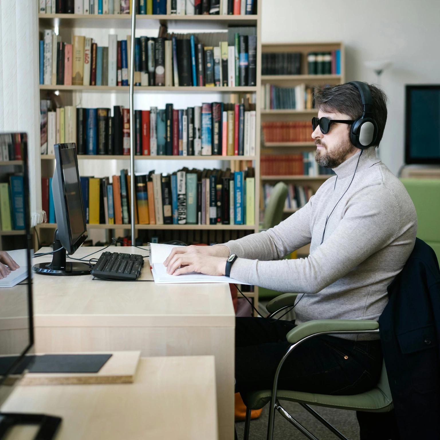 Vision-impaired man using assistive technology